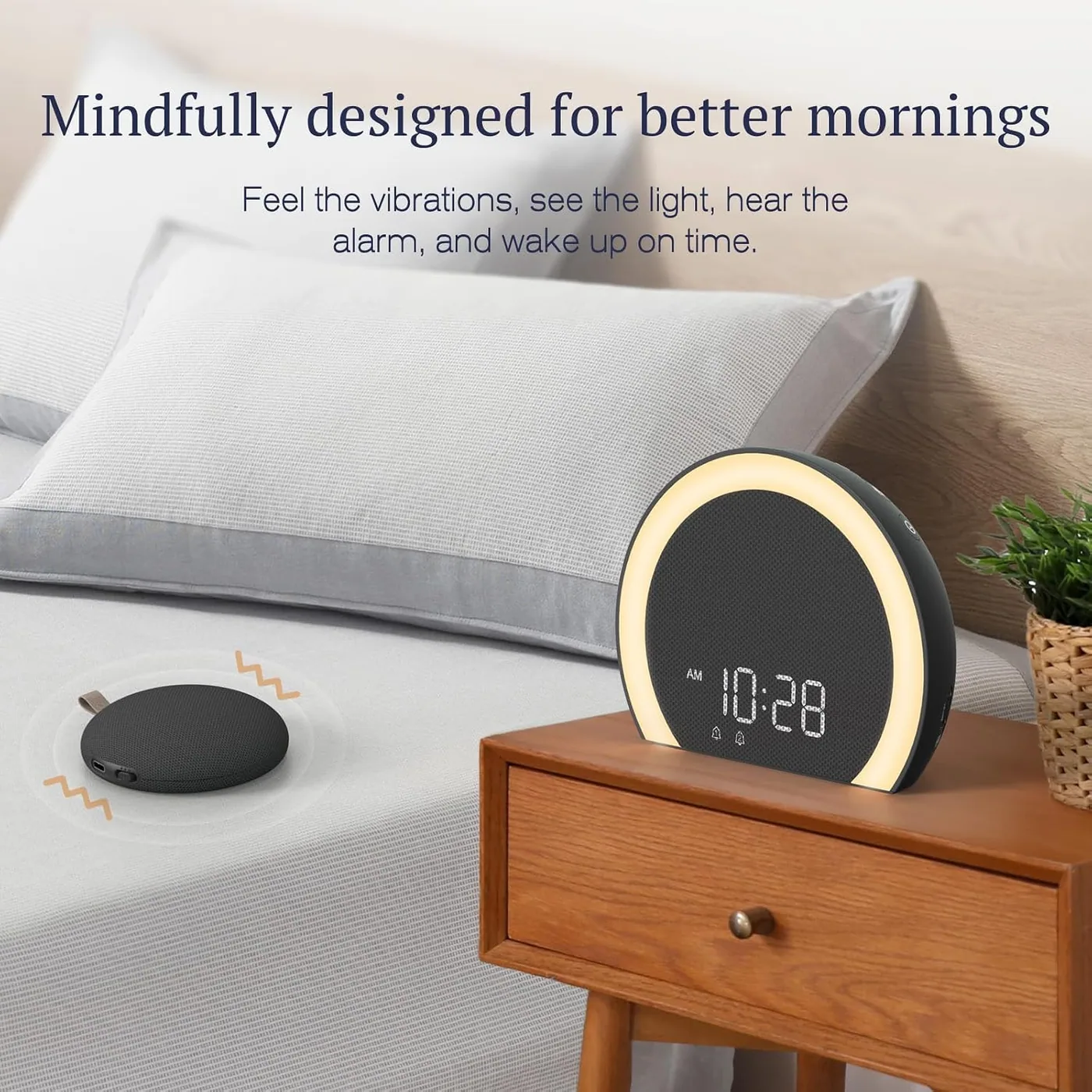 Shaker on the mattress, clock on the nightstand. The puck runs on its own battery for about a month between charges.