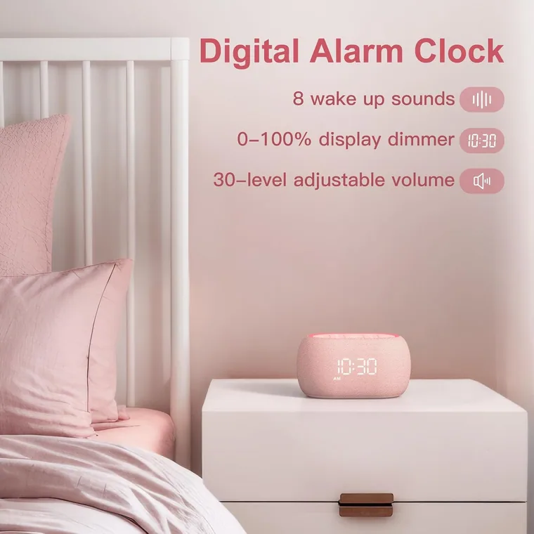 Pink sound machine on a bedside table