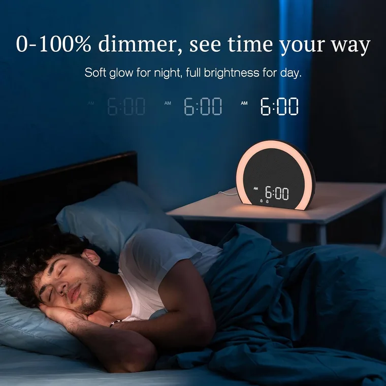 A dark bedroom at night with the clock display dimmed almost to nothing